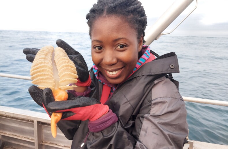 Sinothando Shibe holds a seapen. Credit: Kerry Sink.